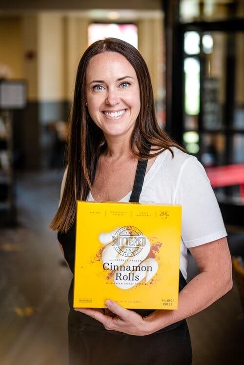 Alicia holding Freshly Frozen Cinnamon Rolls